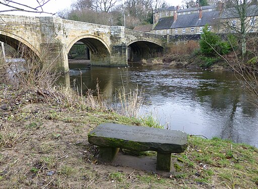 A stone seat to enjoy the view of the Old Bridge at Felton